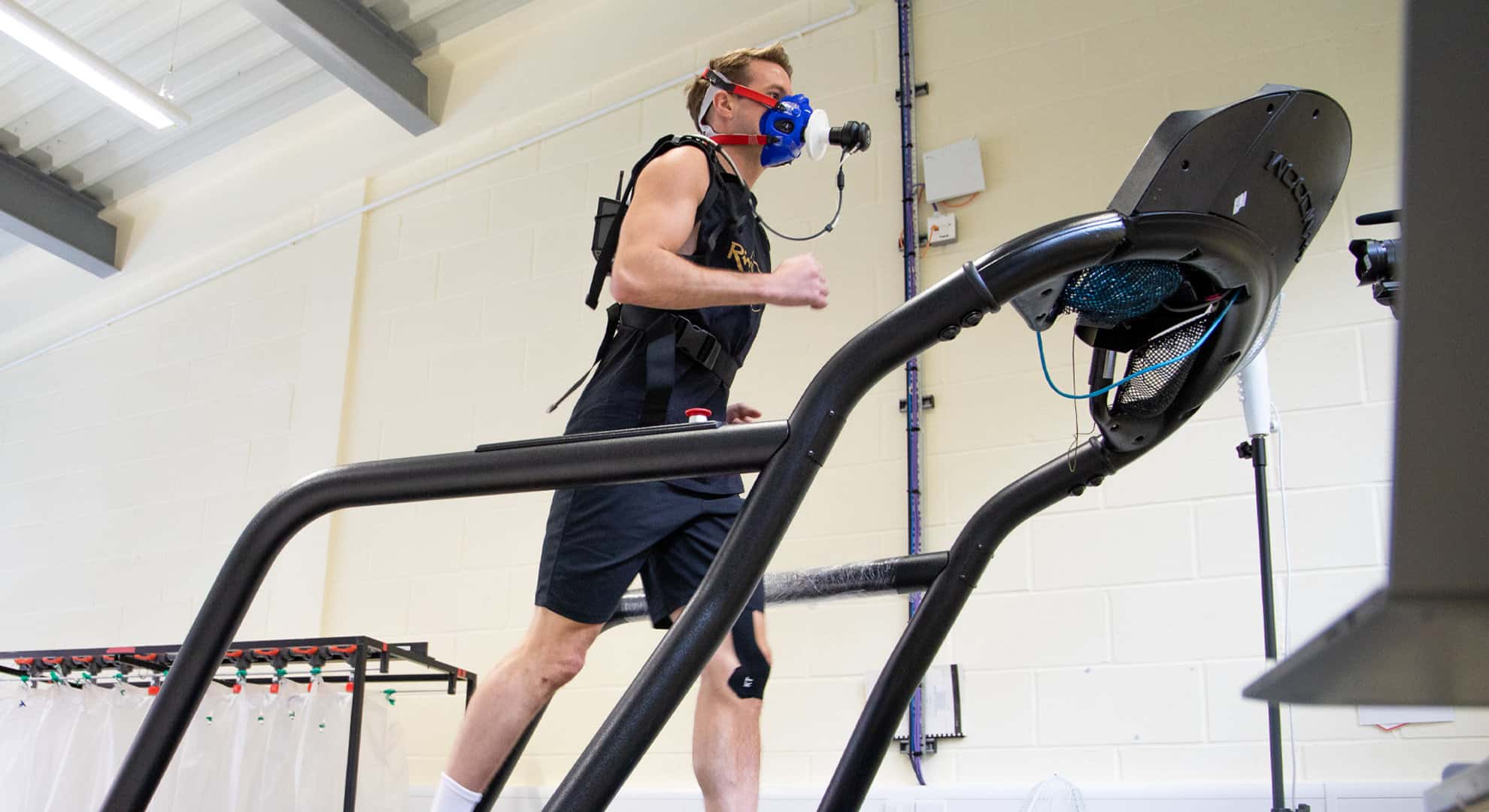 man running on treadmill with oxygen mask